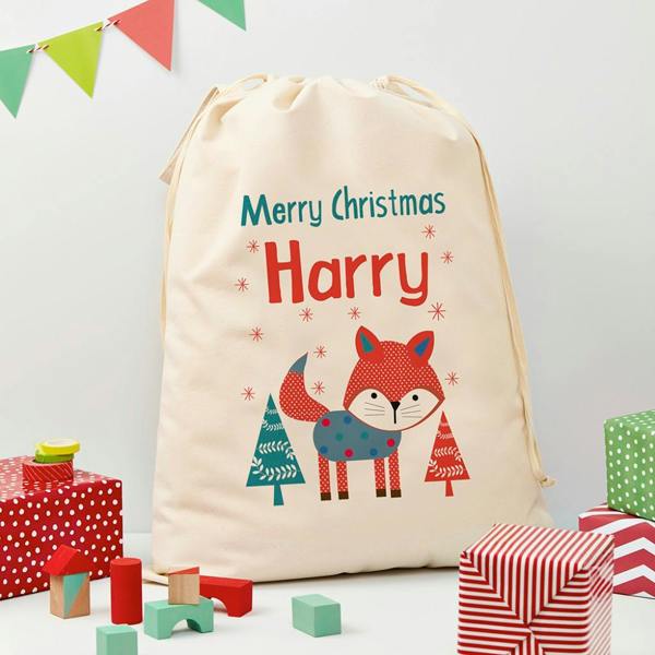 A large canvas Christmas sack from Abode Home & Gifts printed with 'Merry Christmas Harry' and an illustration of a festive fox.