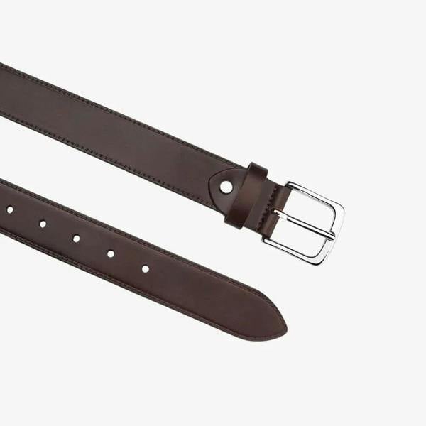 Top angle view of Brown leather belt with a silver buckle on a white background