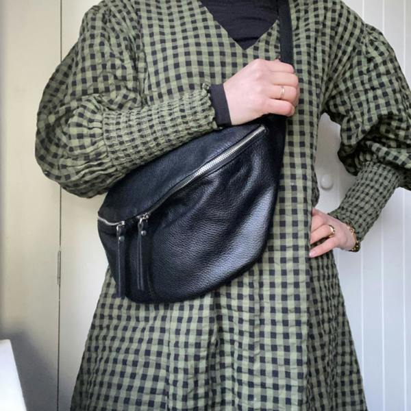 Black large leather bumbag with exposed zips.