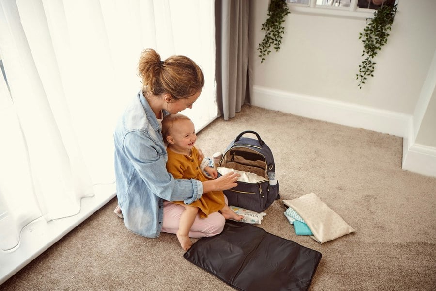 waterproof baby changing mat with mother about to change baby