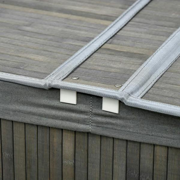 Grey fabric-lined lid with latch detail on bamboo laundry basket