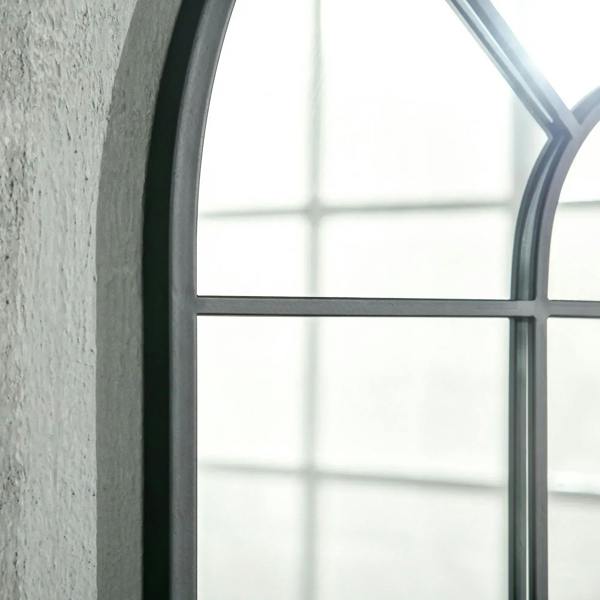 Close-up of arched grid mirror with black frame and vertical horizontal panel bars.