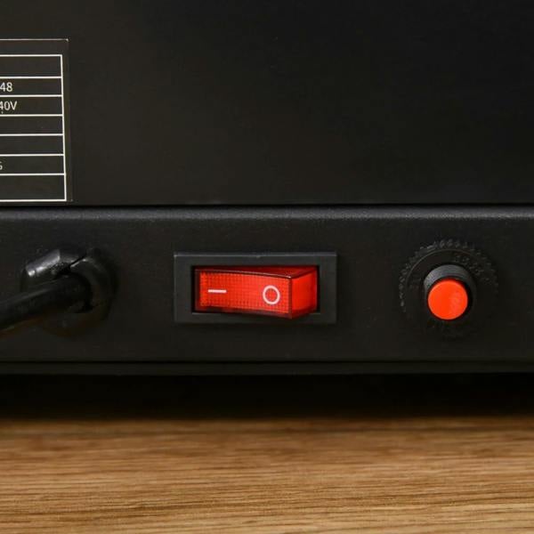 Black treadmill power panel with red switch and indicator light