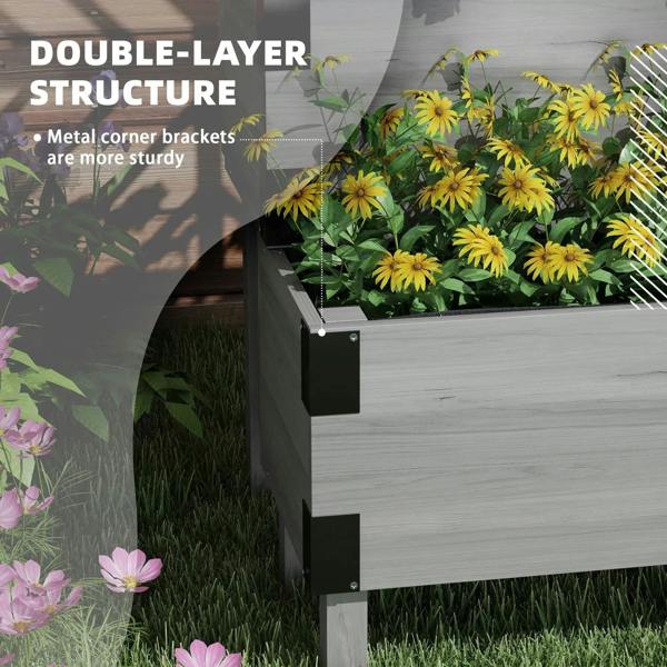 Grey raised garden bed side view with trellis and large front planter of flowers