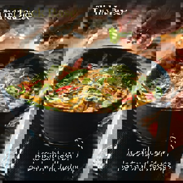 Wok with stir fry noodles. Text reads: Thick base provides incredibly even heat on all stovetops.