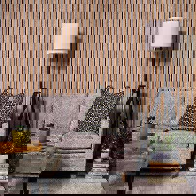 Living room with a gray sofa, patterned pillow, and oak slat wall panels