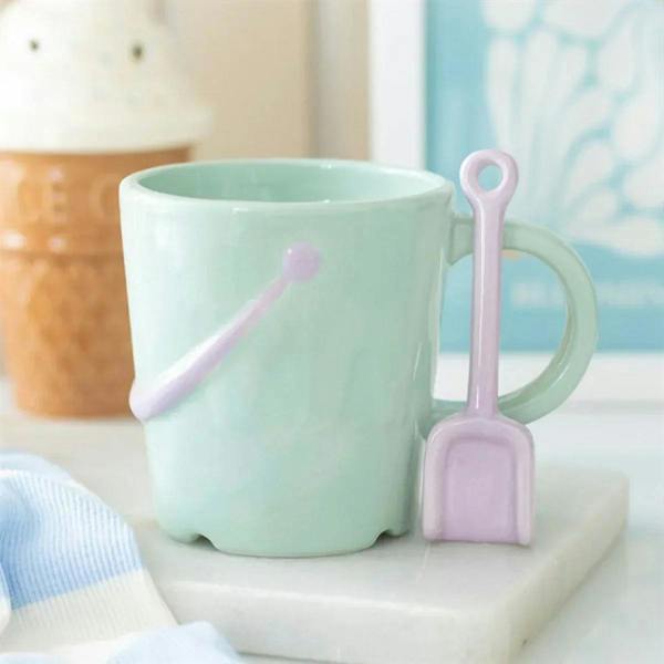 Mint pastel bucket mug with pink spade spoon accessory and dot accent