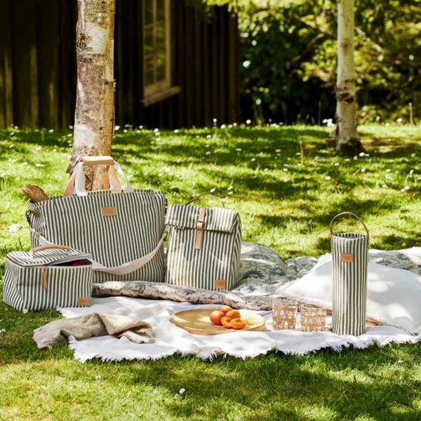Collection of moss green striped picnic bags and rattan baskets for outdoor dining.