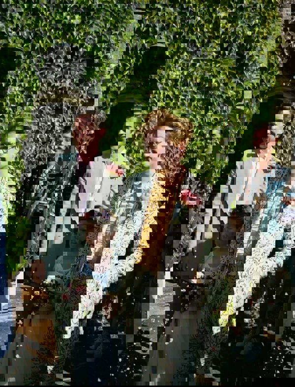 Two men getting married with flower girl 