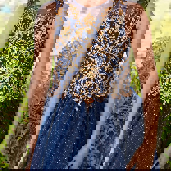 girl wearing a navy and gold sequin dress