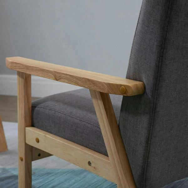 Grey upholstered accent chair with light wood armrest and cushioned seat