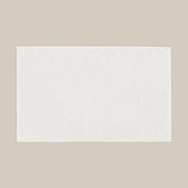 White bath mat made from organic cotton. Soft and sustainable bathroom accessories.