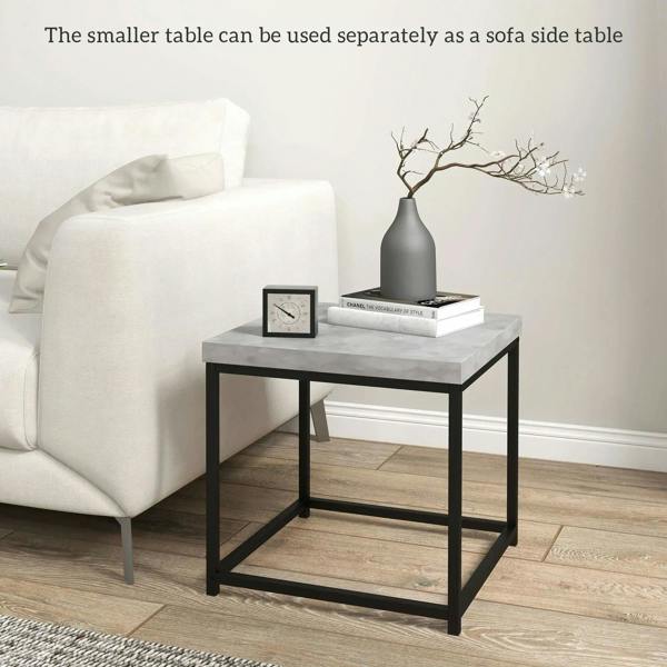 Grey nesting coffee table set of 2 with black metal frame, holding books and decor
