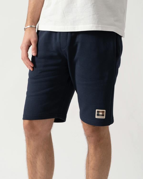 Close up shot of a model wearing a Aquascutum Mens Badge Shorts in Navy 11