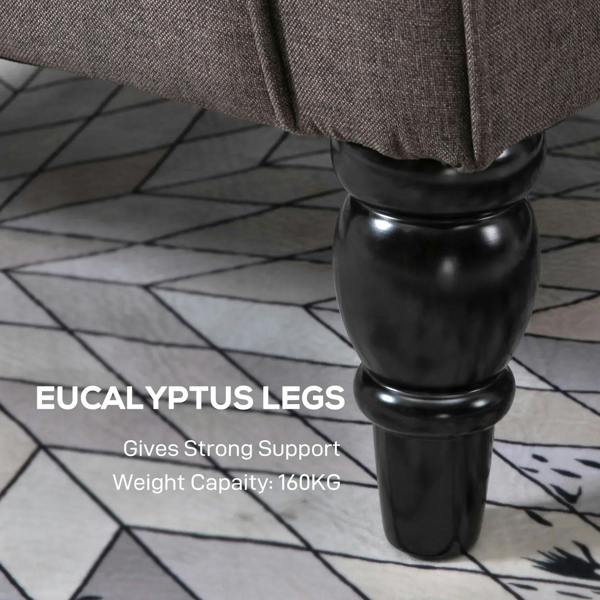 Turned black legs of a brown upholstered accent chair with arm supports