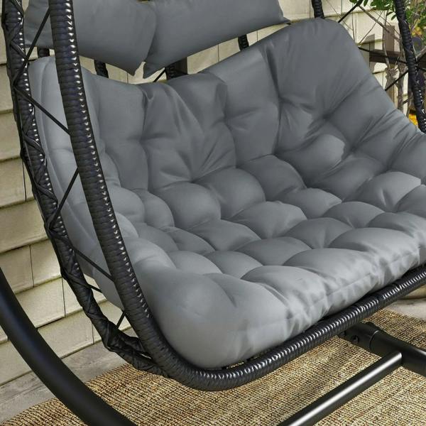 Close-up of gray tufted cushion on black woven hanging egg chair seat