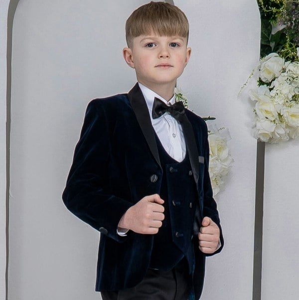 young model wearing his 5 piece navy tuxedo
