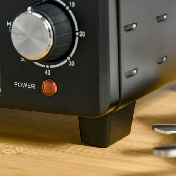 Black mini oven front panel with large temperature knob and glowing power light