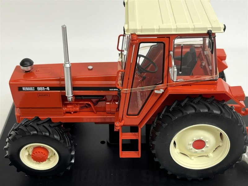 a toy tractor on a black surface