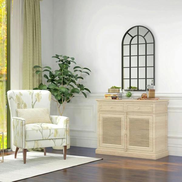Black arched wall mirror with window grid frame in a bright living room