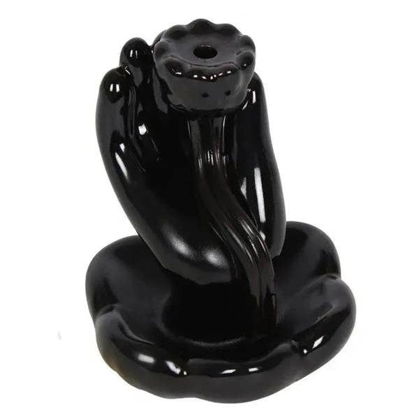 Glazed black hand backflow incense burner close-up with standing cone holder and tray base