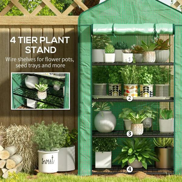 Green four-tier plant greenhouse with wire shelves and roll-up door, plants inside