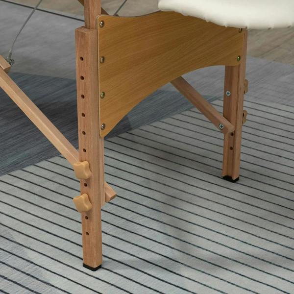 Wooden folding massage table base with height adjustment holes and cream armrest pad