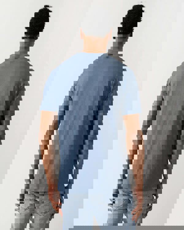 back shot of a model wearing a Armani Exchange Mens T-Shirt with Small Milano-New York Logo in China Blue