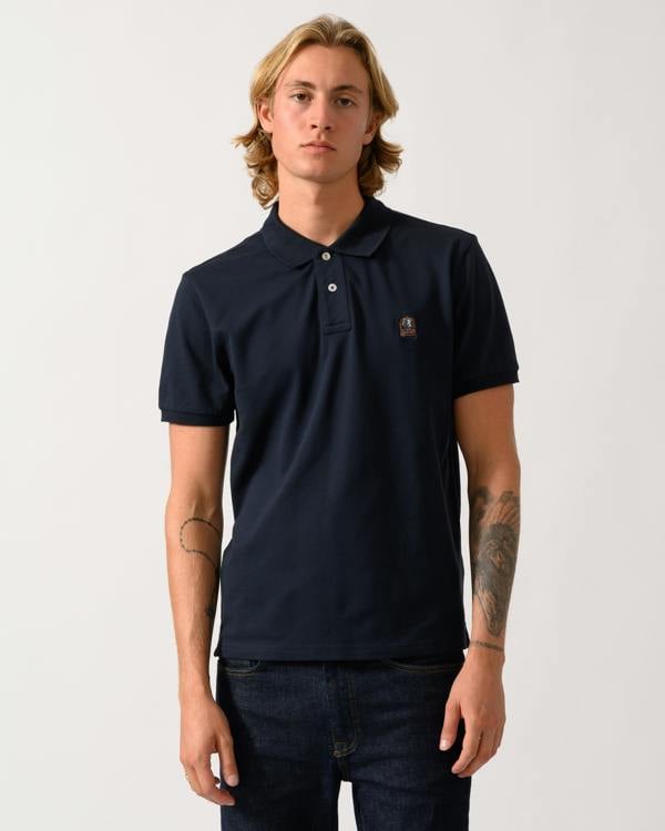 model wearing a Parajumpers Wellington Mens Short Sleeve Polo in Blue Navy 316