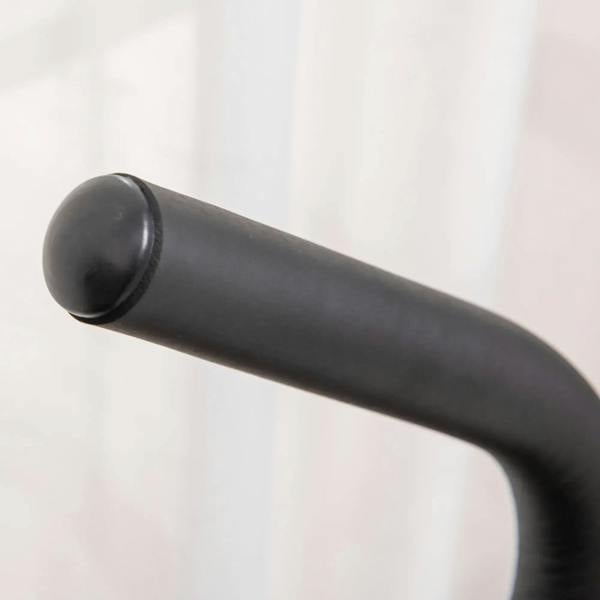 Black padded handlebar on a grey stepper machine for a secure grip