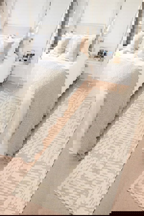 Ava Pave Wave Illusion Rug in cream abstract design enhancing a stylish bedroom with soft textures.