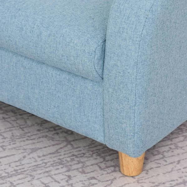 Close-up of blue armchair corner padding and wooden leg