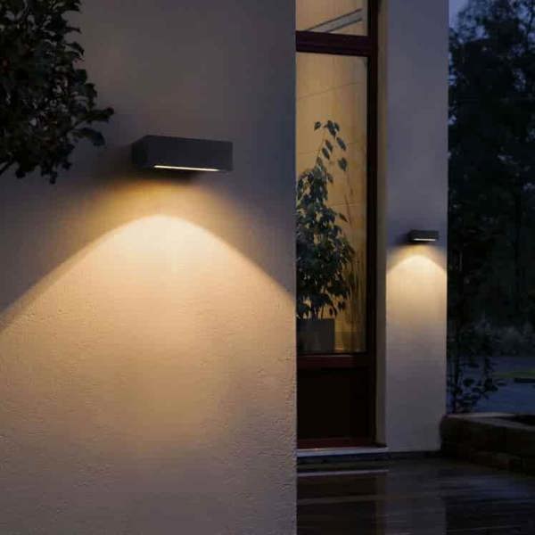 black outdoor down wall light fitted on the exterior walls of a modern house 