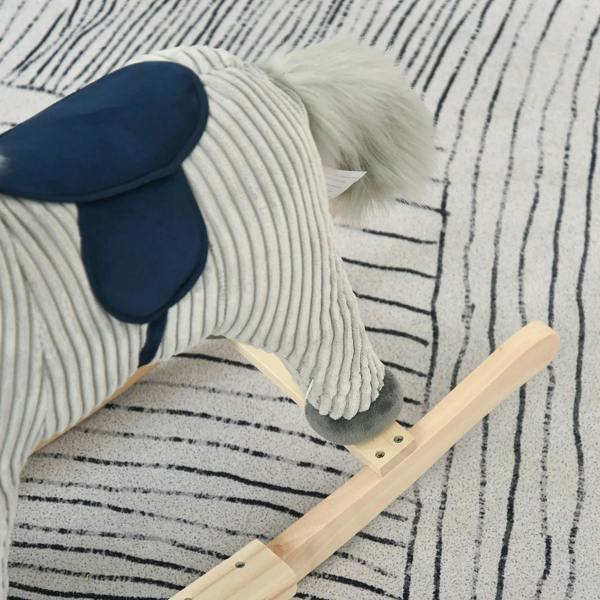 Grey plush rocking horse foot on wooden rocker bar, navy saddle edge visible