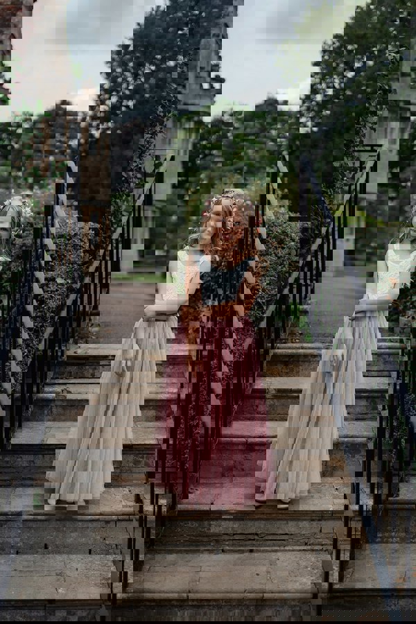 flower girl stood on steps