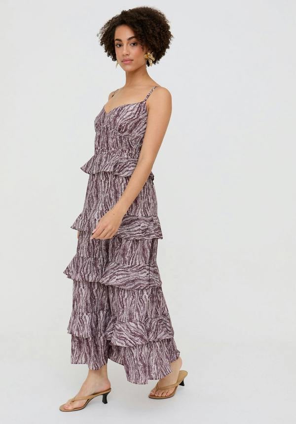 Woman wearing a tiered dress with a zebra print pattern on a white background