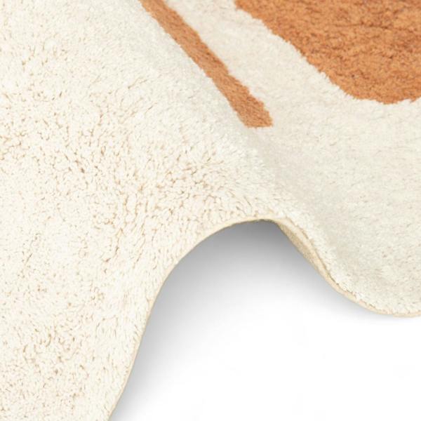 Close-up of a textured beige and brown rug corner on a white background