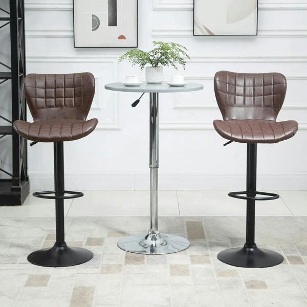 Pair of brown bar stools with tufted PU leather backrests, swivel bases, and footrests