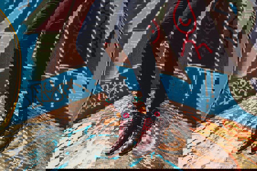 organic cotton spot design socks with formal shoes jumping over graffiti landscape