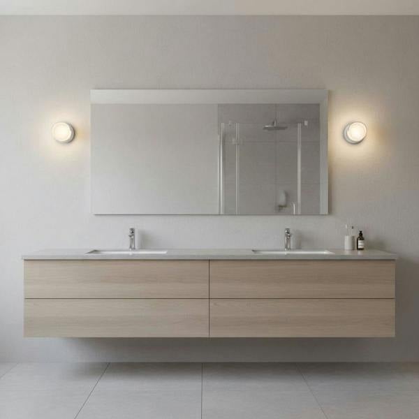 white IP65 bathroom wall lights mounted either side of a mirror in a bathroom 