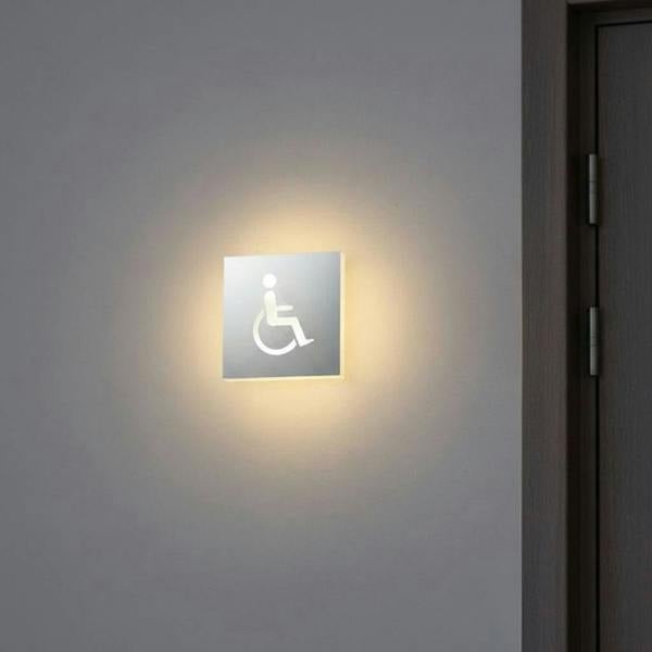 LED disabled toilet sign mounted on the wall outside of a disabled WC