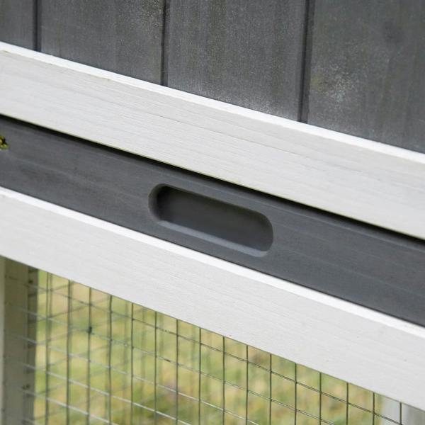 Close-up of white slide-out tray handle under the small animal hutch