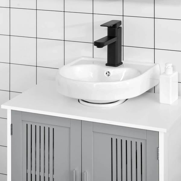 Grey under-sink cabinet with two slatted doors beneath a countertop sink.