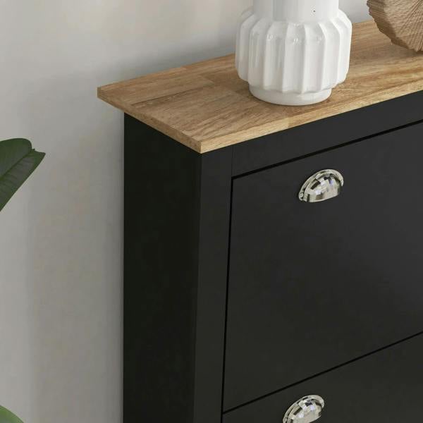 Black shoe cabinet side detail with light wood top and chrome drawer pull