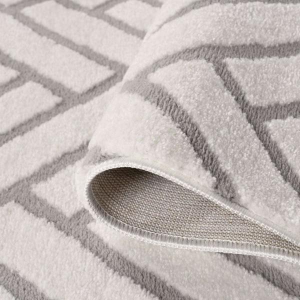 Gray textured rug with a patterned border