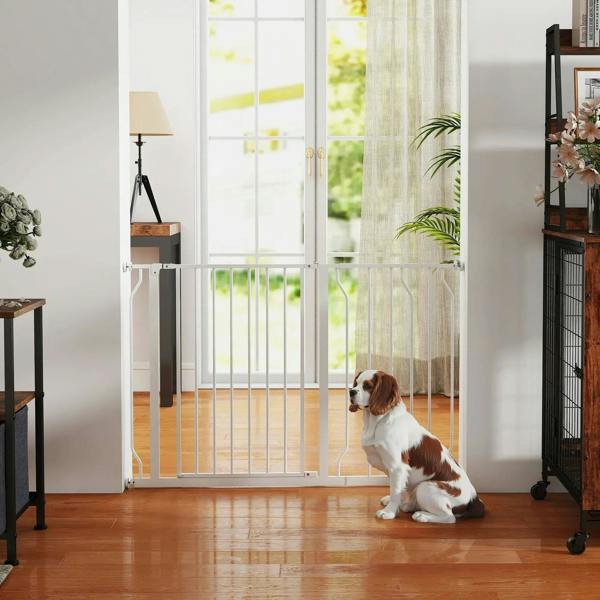 White dog safety gate installed in a room with a pet behind the bars