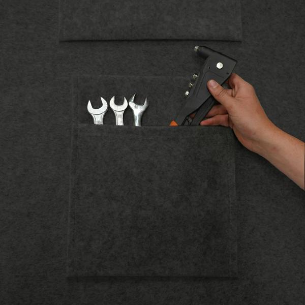Anthracite grey storage pouches with a textured finish, holding tools like wrenches and a hand tool, ideal for organization