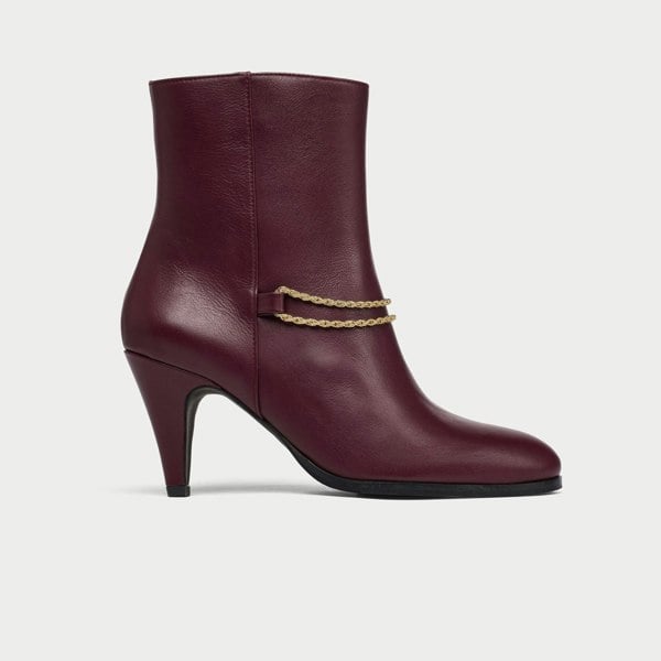 Maya cherry leather boot with gold chain detail on a white background side view