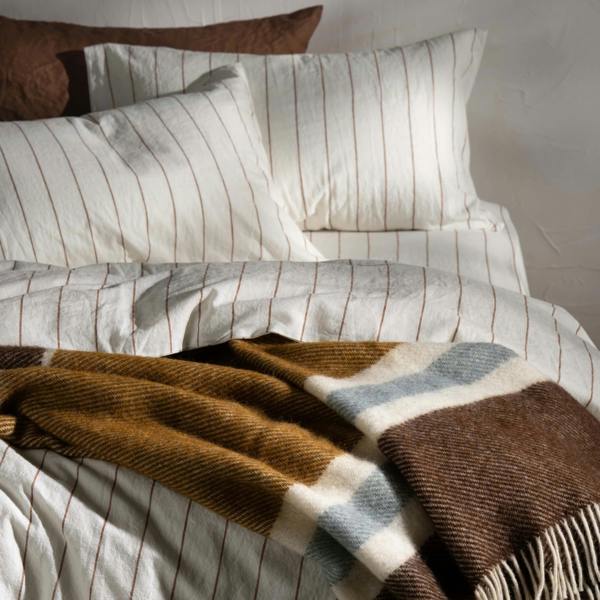 Walnut/Ochre Brushed Wool Multi Stripe Throw - breathable, styled in a bedroom | Soak and Sleep