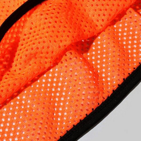Close-up of orange Optimum training bib mesh fabric with black trim showing perforated texture - Optimum